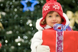 little girl holding christmas present