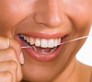 woman flossing her teeth