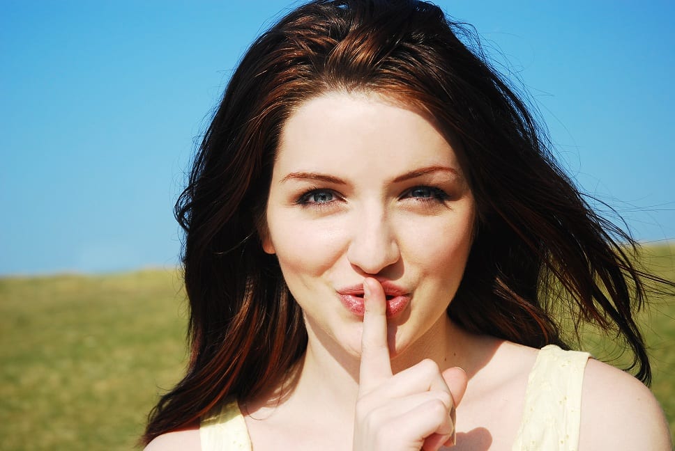 woman with finger to her lips